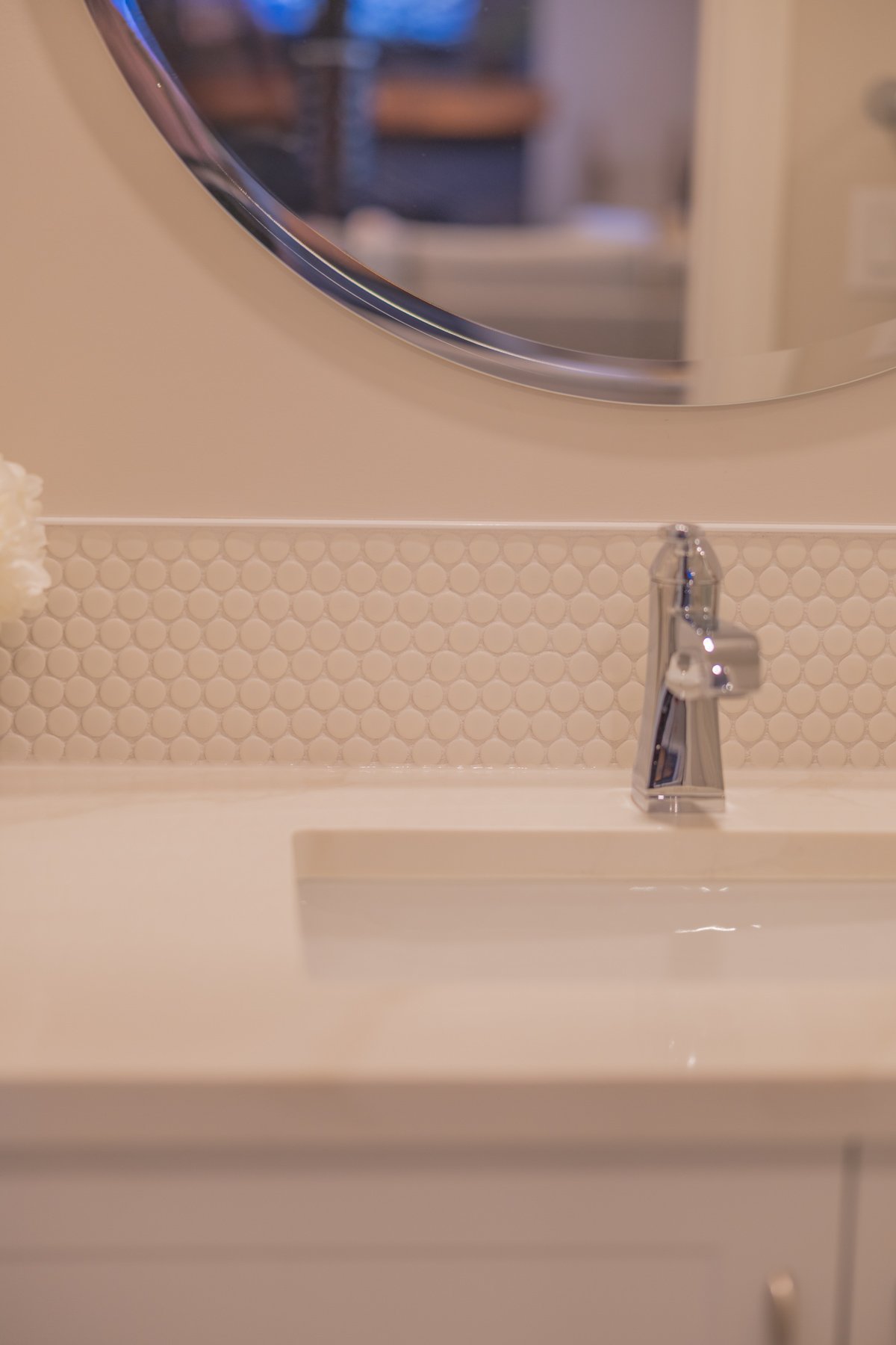 Close-up of the tiled shower surround and contemporary black shower fixtures in the lower-level bathroom.
