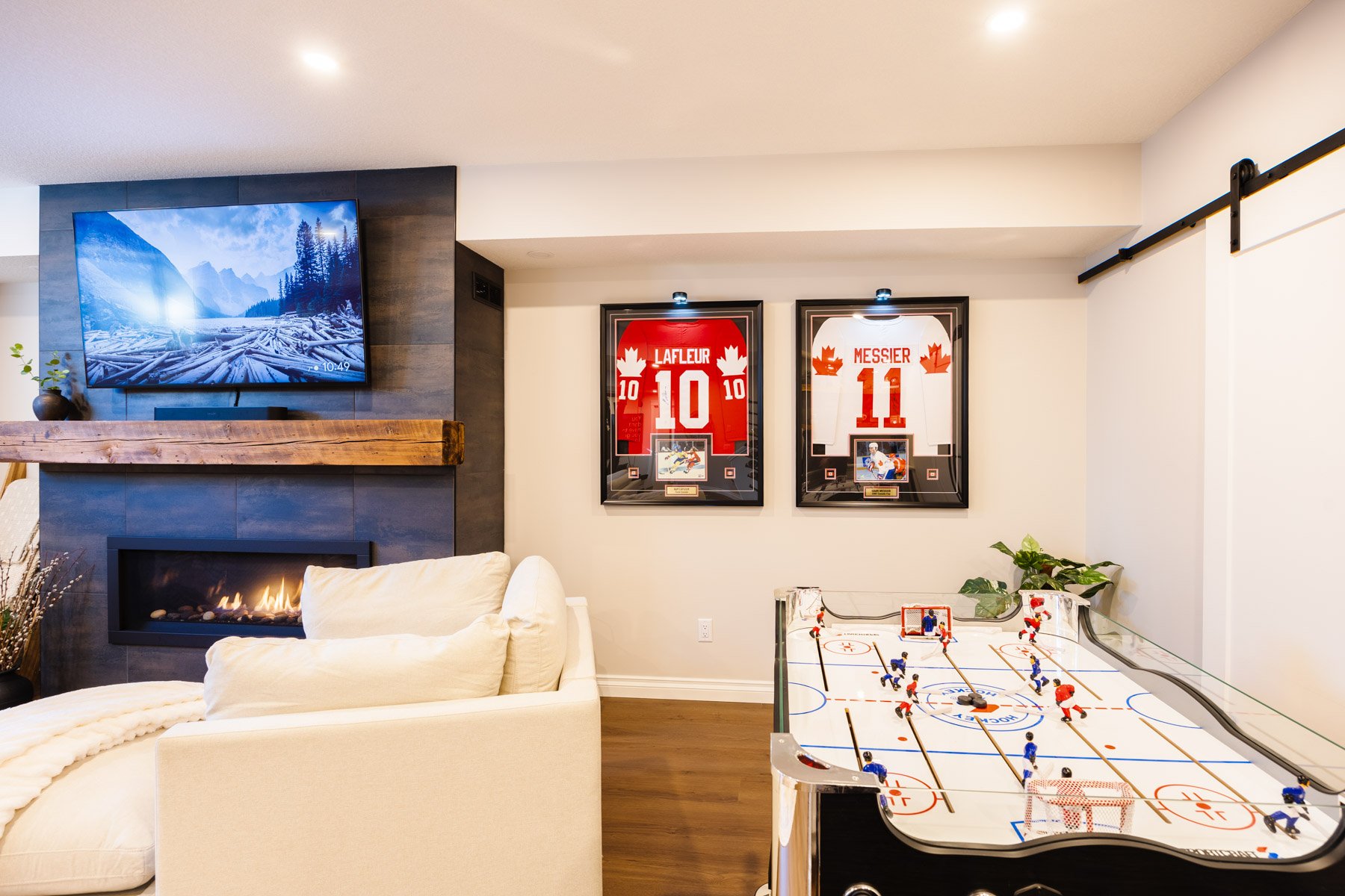 A comfortable lounge area opens directly to the home gym, making the finished basement ideal for daily living.